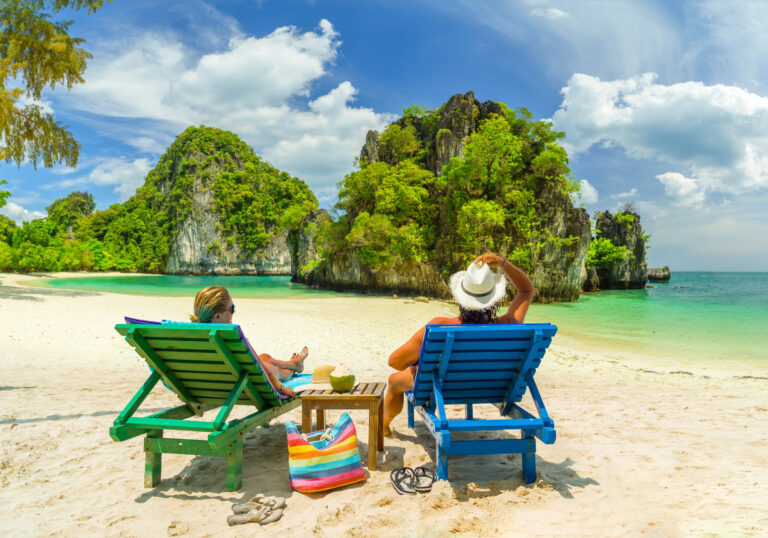 couple-lounging-on-a-sunny-tropical-beach