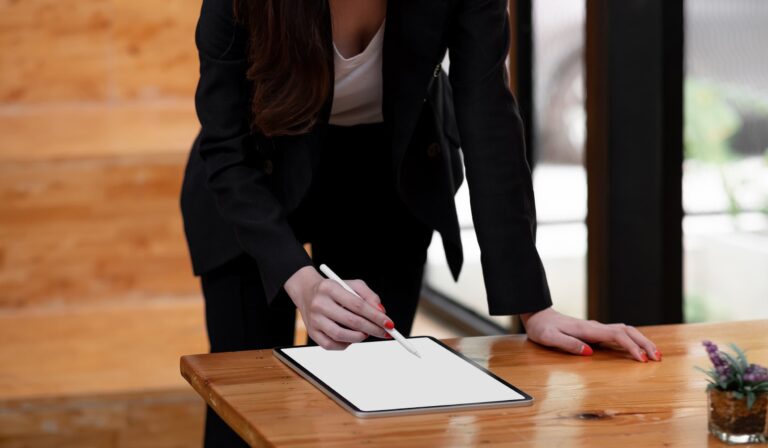 Business Woman Signing Digital Contact on Tablet